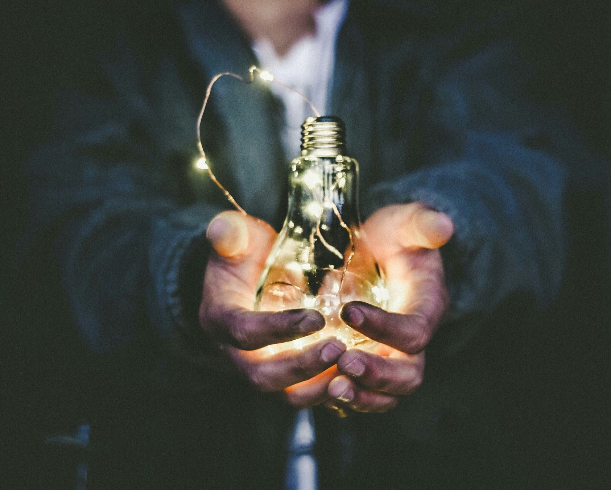 man holding lightbulbs