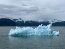 large iceberg floating on top of water